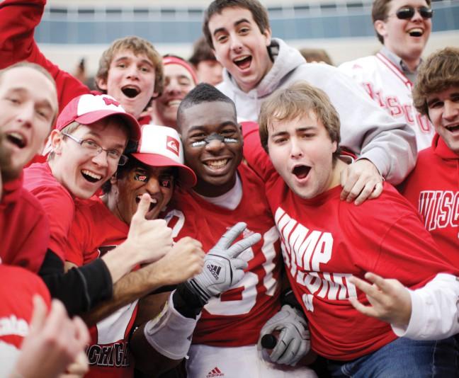 Defensive end O\Brien Schofield poses with fans during fifth quarter after the final home game of his senior season. Officers ejected 49 fans during the UW Badgers\ win against Michigan Saturday at Camp Randall. A total of 34 of the 49 ejections were students. Alcohol-related infractions led to 15 of the ejections, while body passing contributed six.