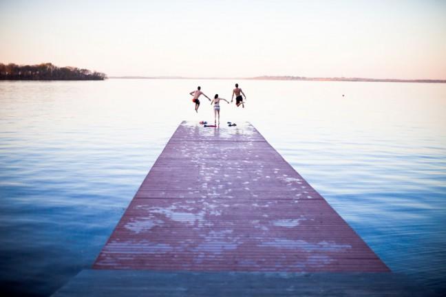 Students take a dip in Lake Mendota to take advantage of unusually warm weather Saturday.