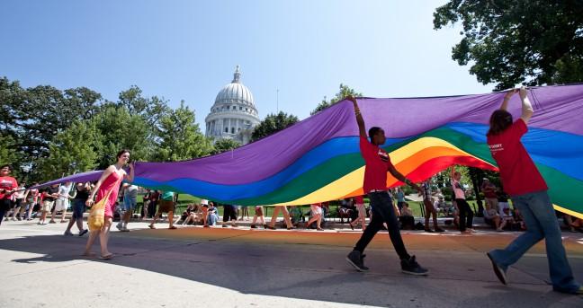 Parade+marchers+hoist+a+giant+rainbow+flag+on+Capitol+Square+during+Pride+Fest+on+Sunday%2C+August+22%2C+2010.