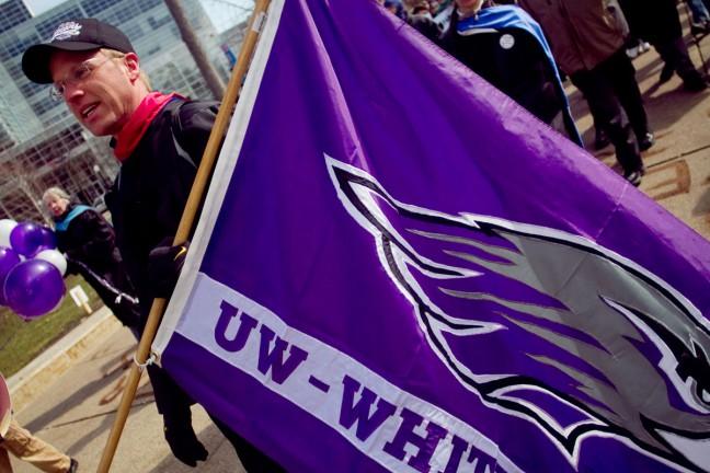 UW-Whitewater+Professor+Eric+Compas+carries+a+flag+he+brought+to+Madison+after+marching+to+the+Capitol+from+the+Whitewater+campus.+Compas+and++another+UW-W+professor+both+walked+the+full+43+miles+between+Whitewater+and+Madison+showing+solidarity+with+labor+unions.