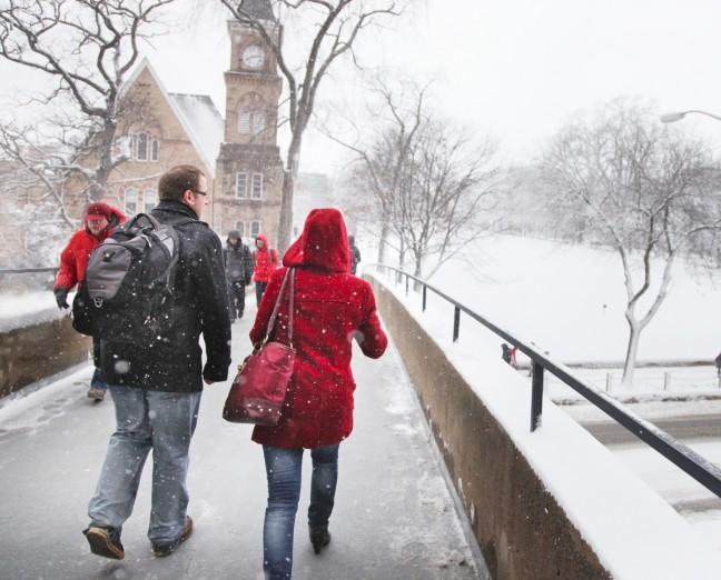 Students brave the weather on campus. The city declared a snow emergency Wednesday, just a day after highs reached the 50s.