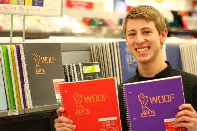WOOF Supplies co-founder Jackson Angell showing off WOOF notebooks in the University Book Store.