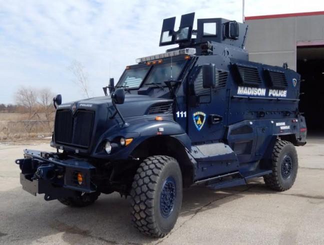 Armored police rescue vehicle parked outside of station.