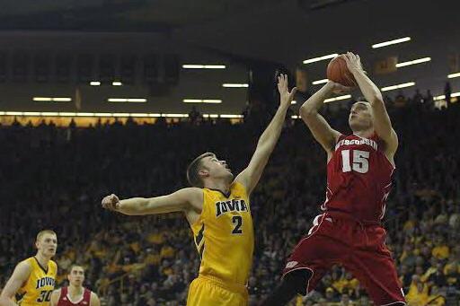 Wisconsin forward Sam Dekker shoots the ball over Iowa guard Josh Oglesby during the Iowa-Wiscosin game in Carver-Hawkeye Arena on Satuday, Jan. 31, 2015. The Badgers defeated the Hawkeyes, 74-63. 