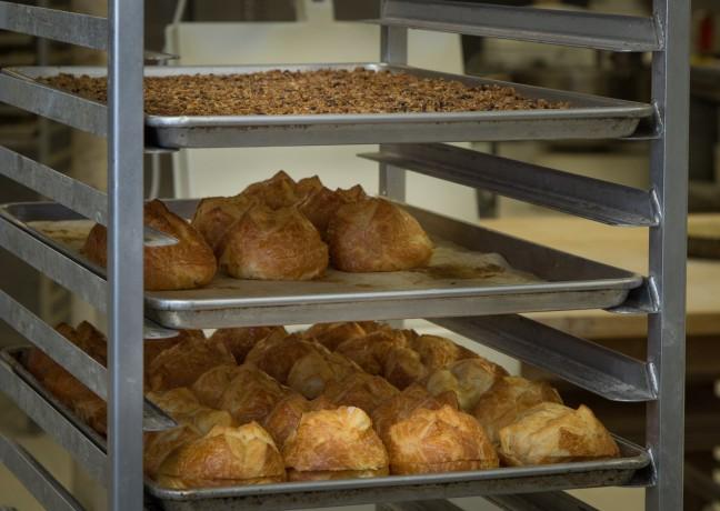 Prepared brioche and other baked goods on racks.