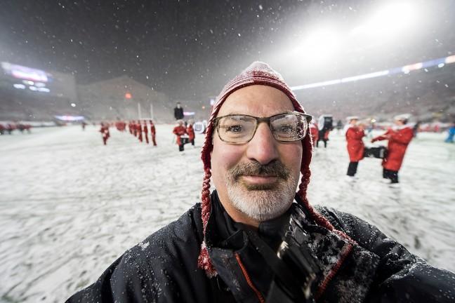 Jeff Miller, senior photographer for University Communications, poses for a self-portrait following the Wisconsin football team's 59-24 victory over the Nebraska Cornhuskers in a football game at Camp Randall Stadium at the University of Wisconsin-Madison during a snowy night on Nov. 15, 2014.
