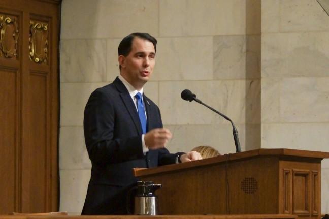 Walker stays loyal to party platform, despite criticism from former cabinet members