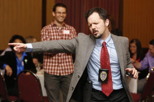 Nick Rowley, playing the role of detective Richard Less, gets excited over clues March 28, 2014 during The Dinner Detective event at the Embassy Suites in Des Moines.