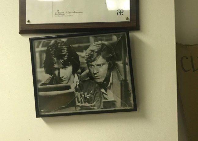 black and white photo from All the Presidents Men featuring Robert Redford and Dustin Hoffmann hanging in Badger Herald office