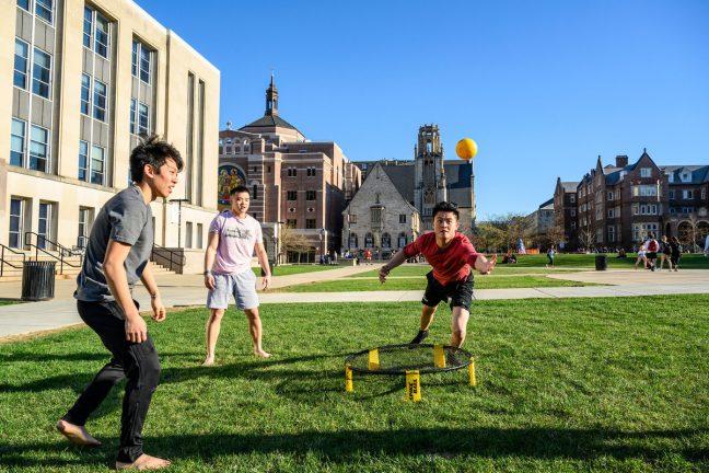 Uw students William Pan (left), Austin Lee (center) and Franky Shi (right) play a game of spike ball during a warm spring day on Library Mall near Memorial Library at the University of Wisconsin-Madison on April 24, 2019.