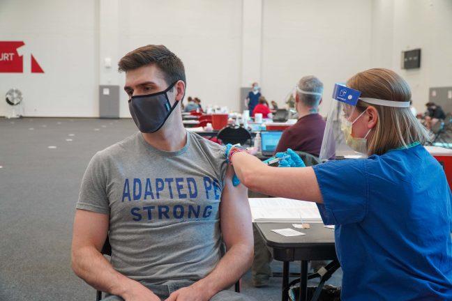 UW Madison Ph.D. student, Carson Keller, getting the COVID-19 vaccine at the Nicholas Recreation Center vaccination site