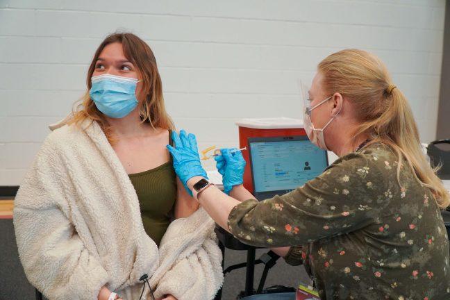 UW Madison freshman, Ellie Grann, getting the COVID-19 vaccine at the Nicholas Recreation Center vaccination site