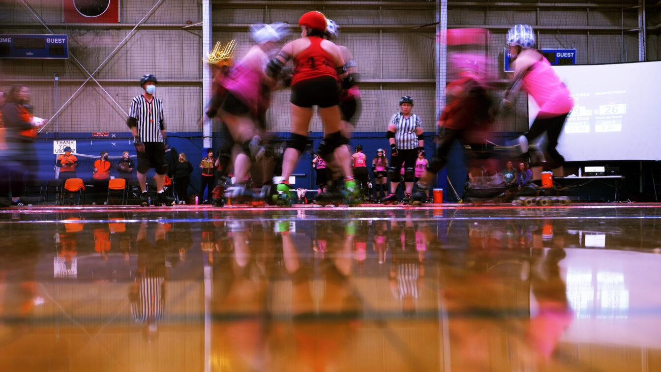 held shutter movment of the women playing roller derby. 