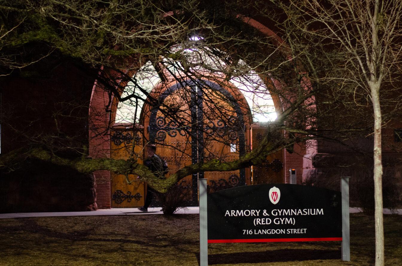 A student exits UW's Red Gym, where the APIDA Student Center is housed.
