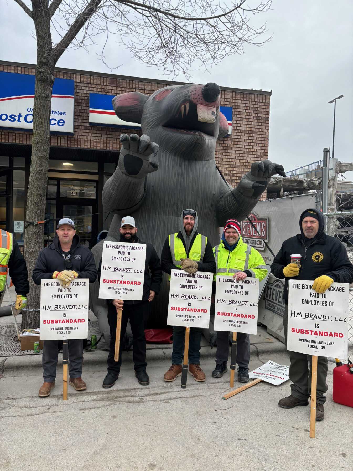 Demolition workers protesting HM Brandt, LLC outside of their downtown worksite in February.