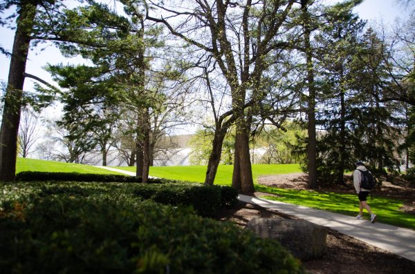 A student walks up the hill at Camp Randall Veteran Park. April 23, 2024.