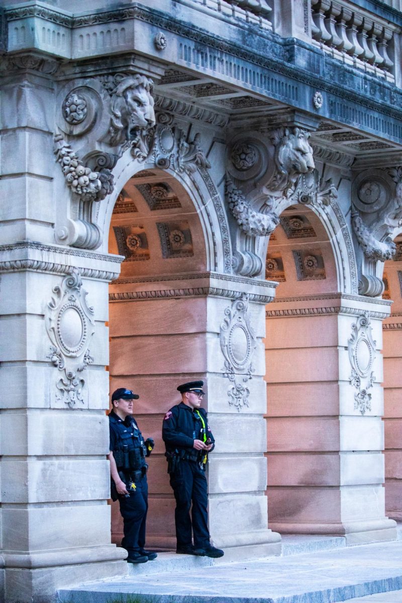 Two UWPD officers stand at the entrance of the Wisconsin Historical Society, monitoring the encampment. April 30, 2024.