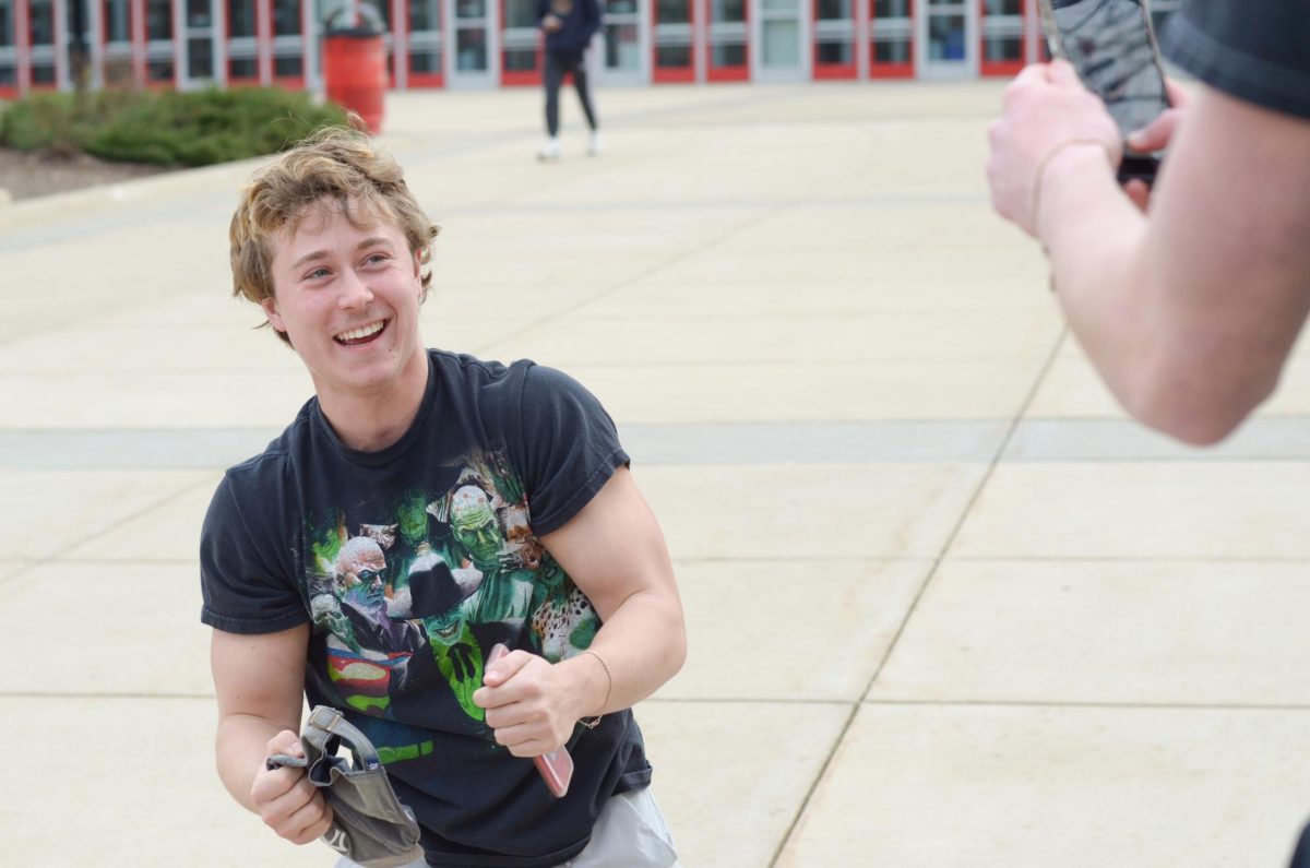 Weston laughs after filming a clip for a TikTok in front of the Kohl Center with comedic partner Jack Couey. The two often incorporate elements of the UW-Madison campus, making their TikToks engaging for fellow students. 
