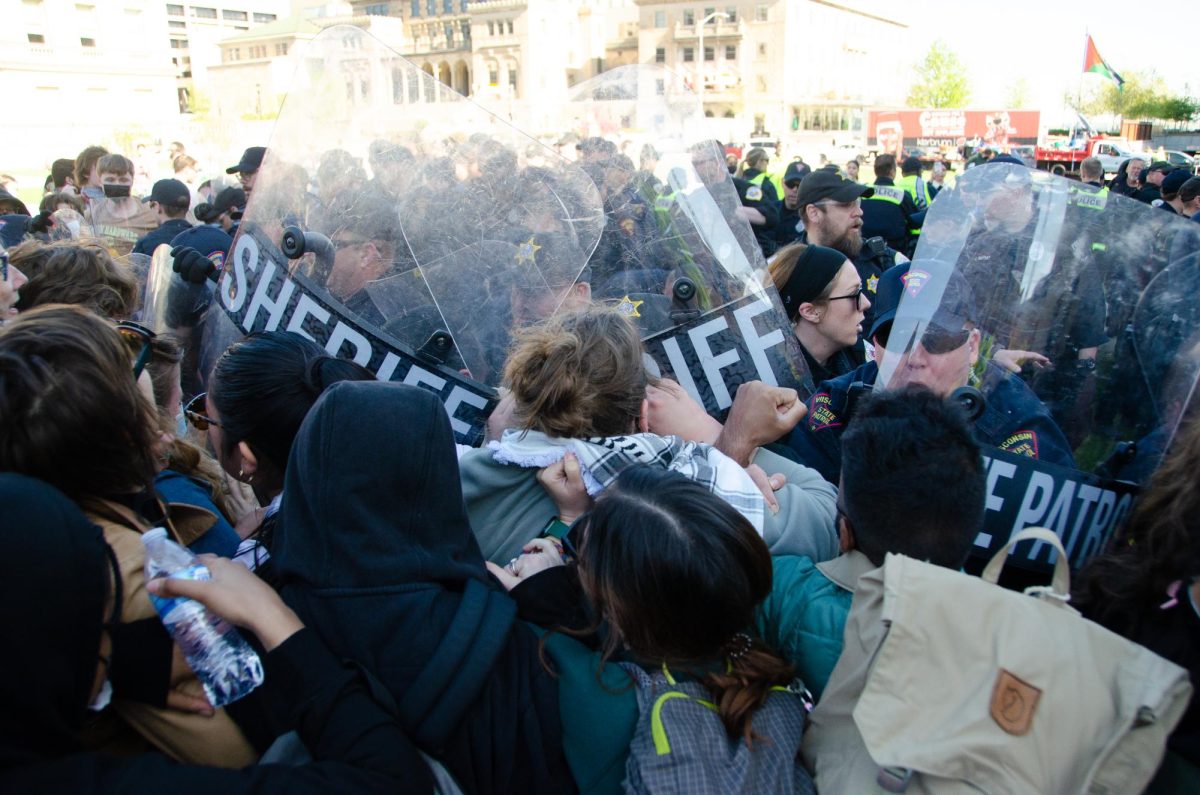 Police and demonstrators clash at Library Mall on the morning of May 1, 2024.