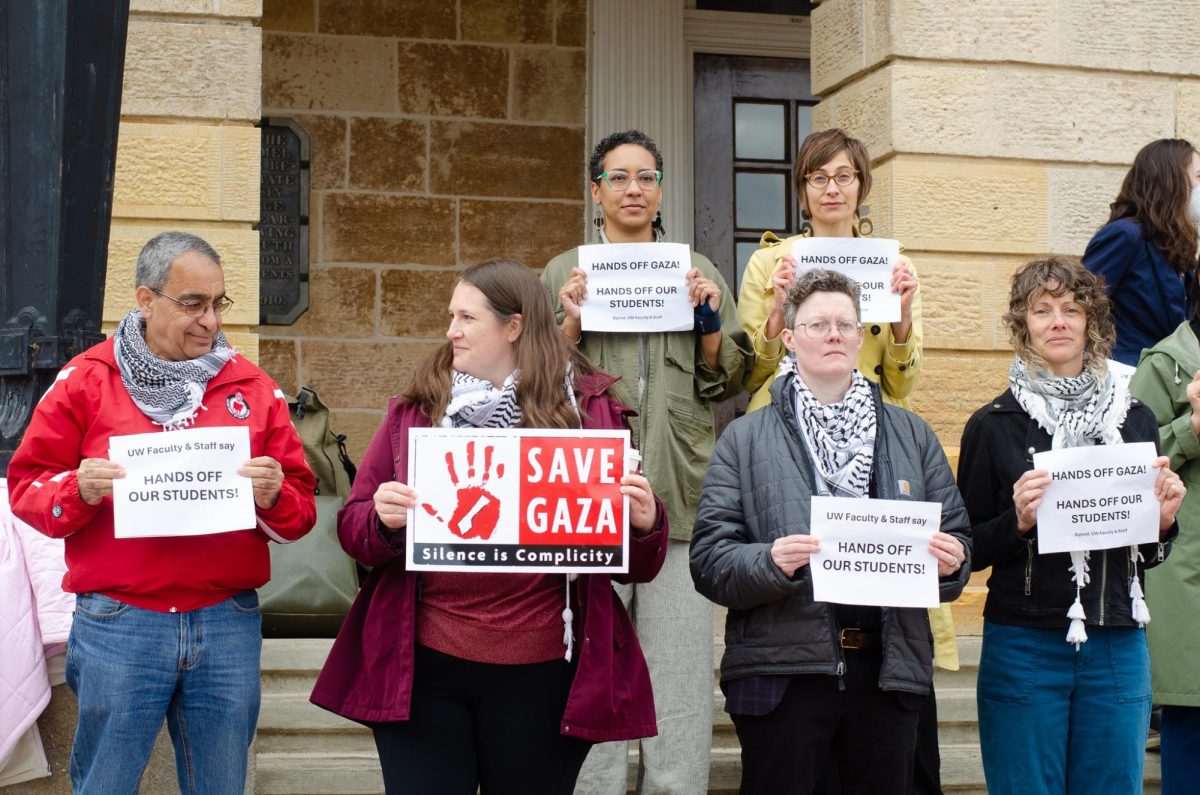 Faculty and staff stand outside of Bascom Hall protesting. May 2, 2024