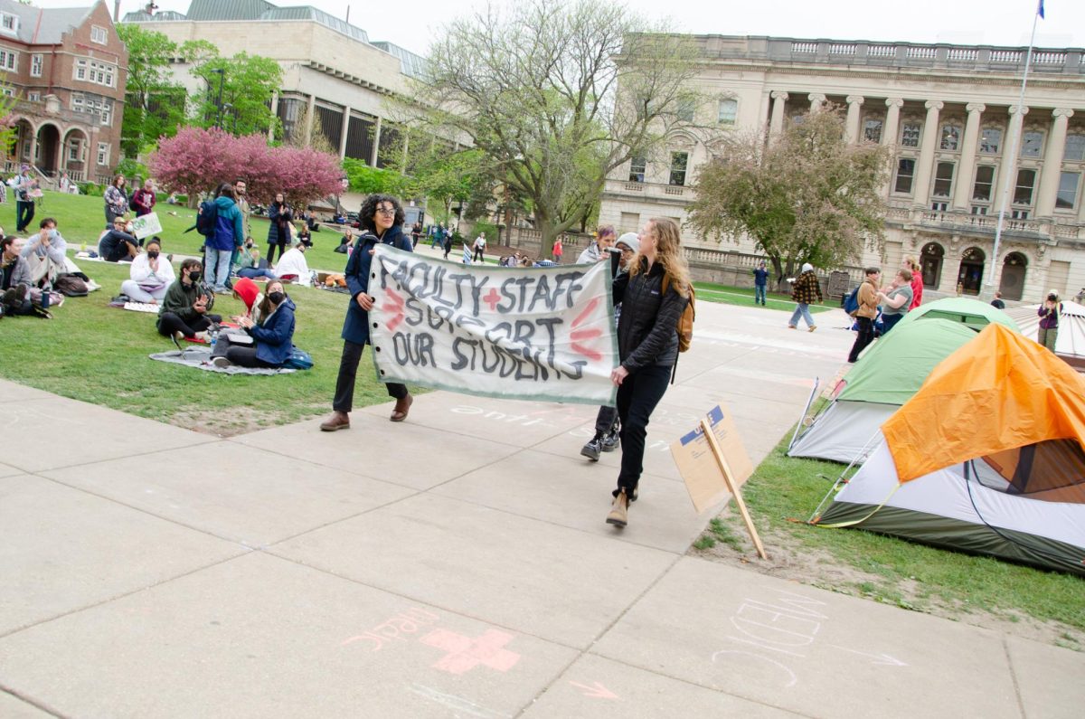 Faculty and staff of UW-Madison march back from Bascom Hall after a meeting with Chancellor Mnookin came to a close on May 2, 2024. The meeting was between university staff and protest organizers.