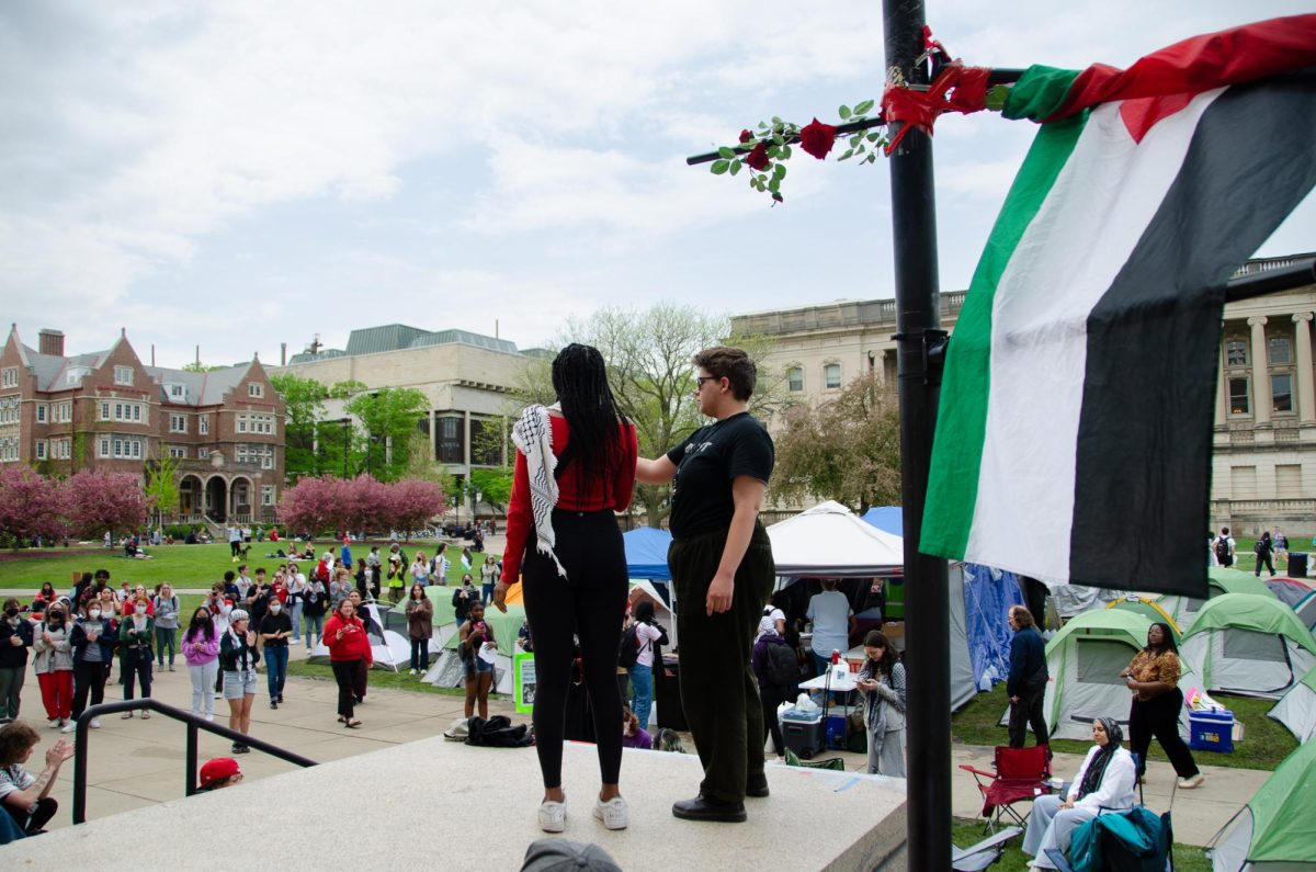 Madison West student Maliha Nu’Man, the 2023-24 Madison Youth Poet Laureate, reads a self-written poem about resistance to a crowd of protesters at Library Mall on May 2, 2023.
