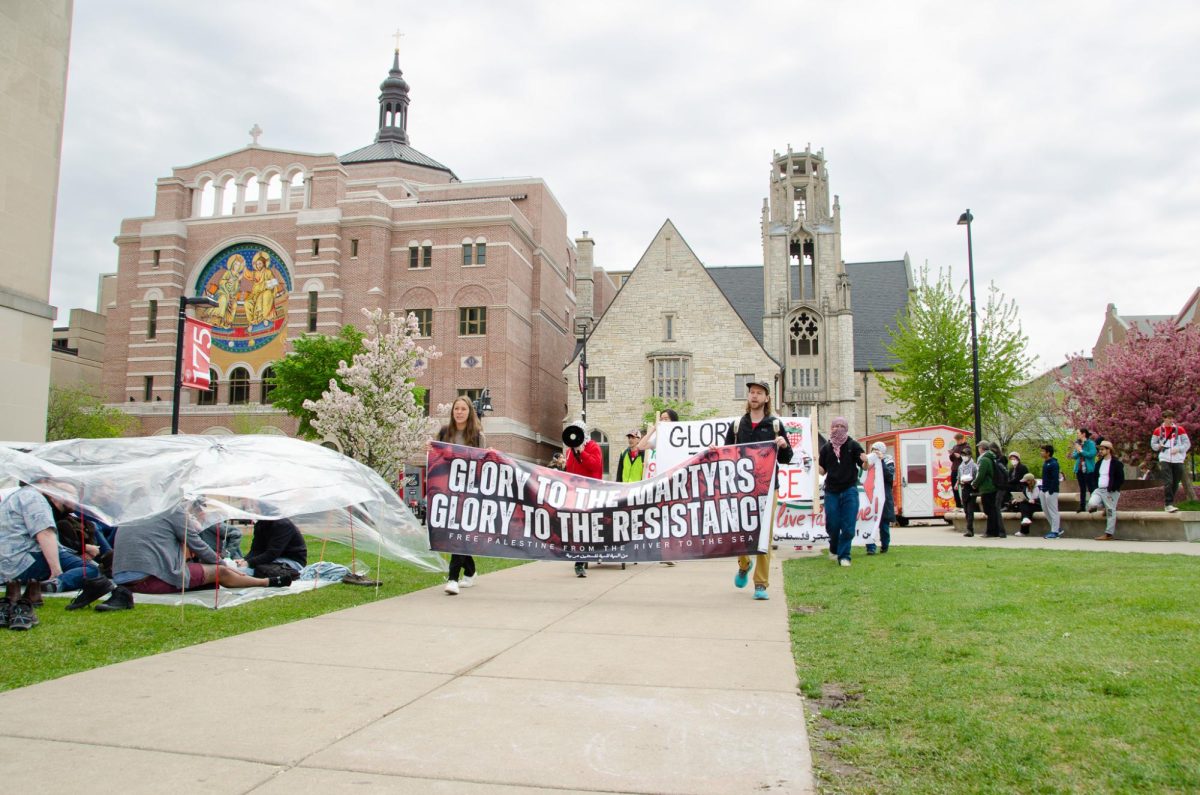 UW-Madison students enter the encampment at Library mall chanting and displaying banners on May 2, 2024. 