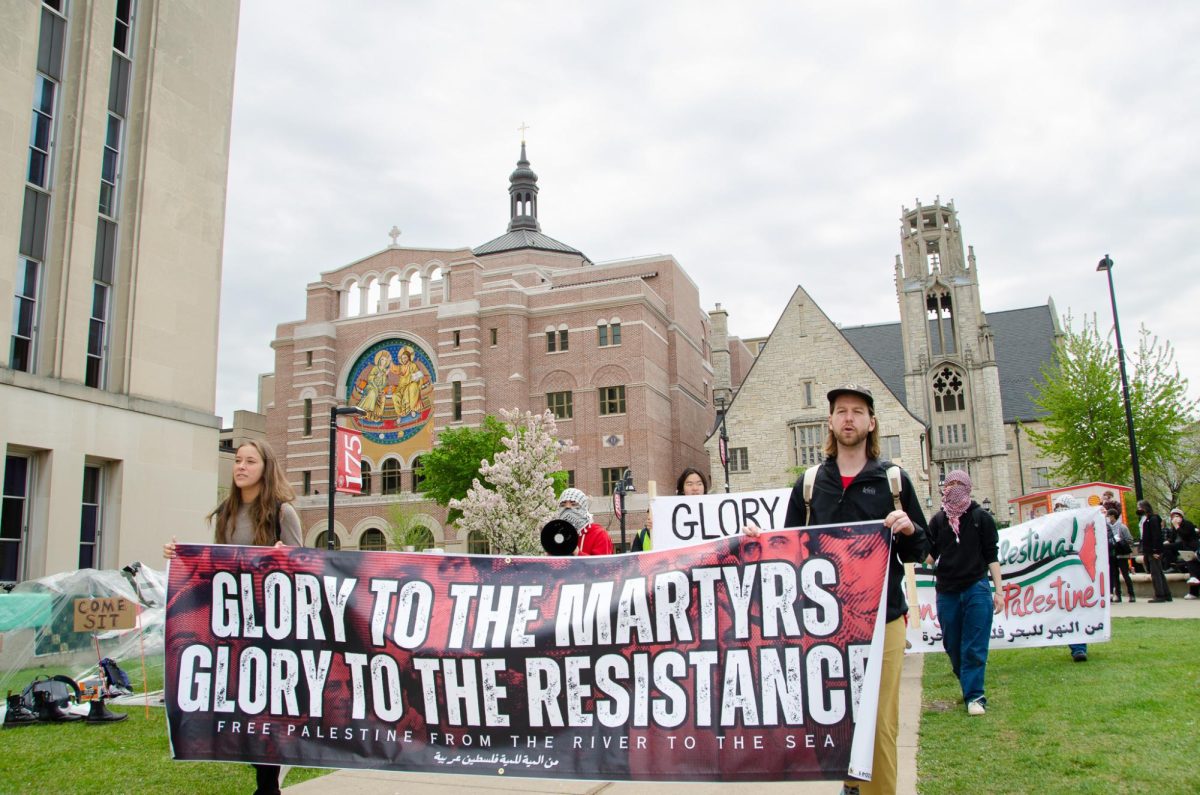 UW-Madison students enter the encampment at Library mall chanting and displaying banners on May 2, 2024. 