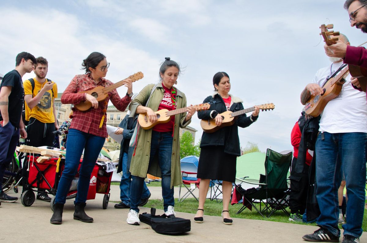 A group of six musicians play latin music in support of Palestine at Library Mall on May 2, 2024. 