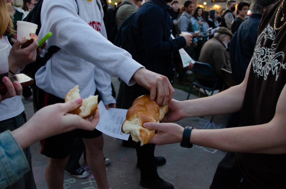Demonstrators share bread at the Jews for Palestine Liberation Camp on May 3, 2024.