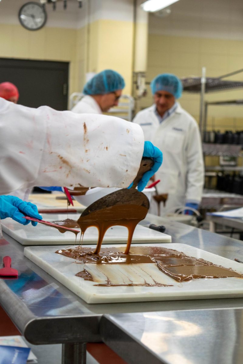 Students work with liquid chocolate in room B120 of Babcock Hall. Aug. 2, 2024. 