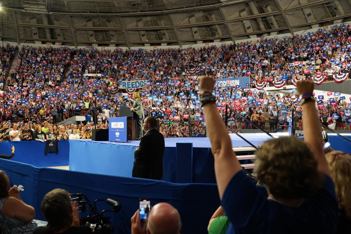 A rally goer cheers as Vice President Kamala Harris speaks at her rally in the Veterans Memorial Coliseum in Madison, Wisconsin. September 20, 2024.