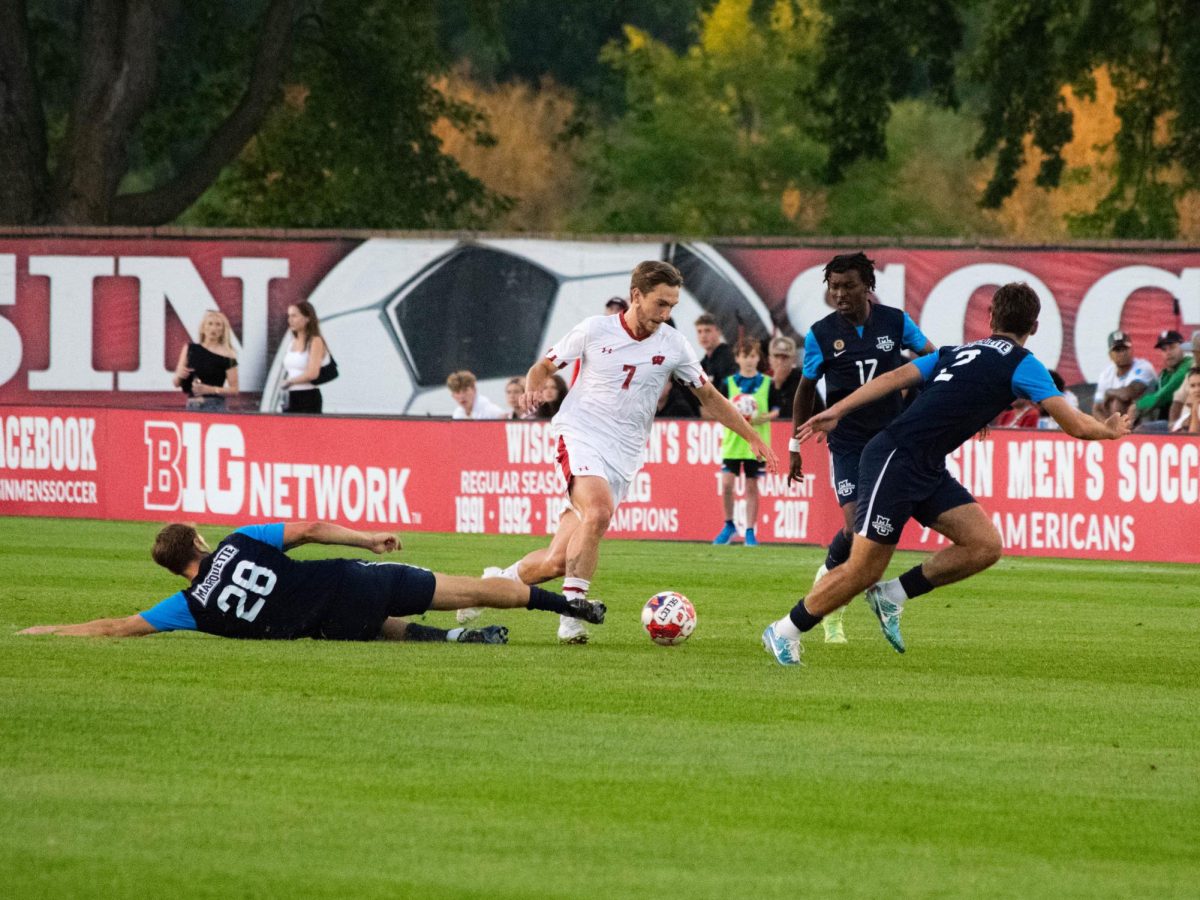 Kevin Andrews narrowly avoids a slide tackle.