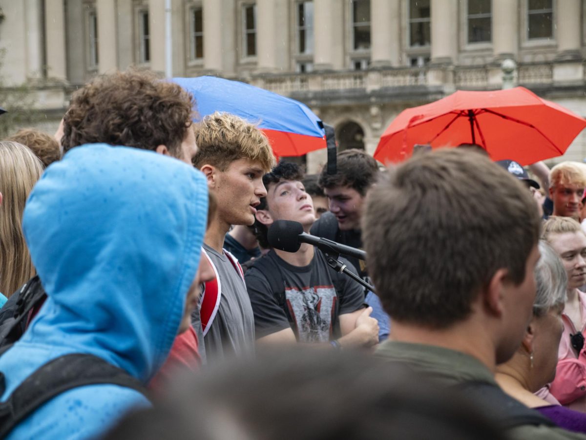 Student speaking at Charlie Kirk event on Library Mall. 