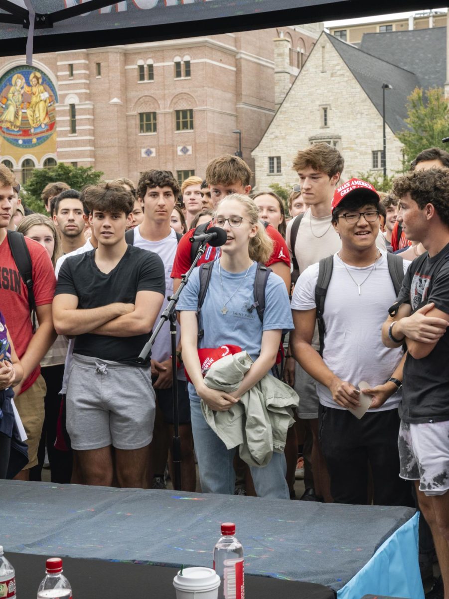 Student speaking at Charlie Kirk event on Library Mall. 