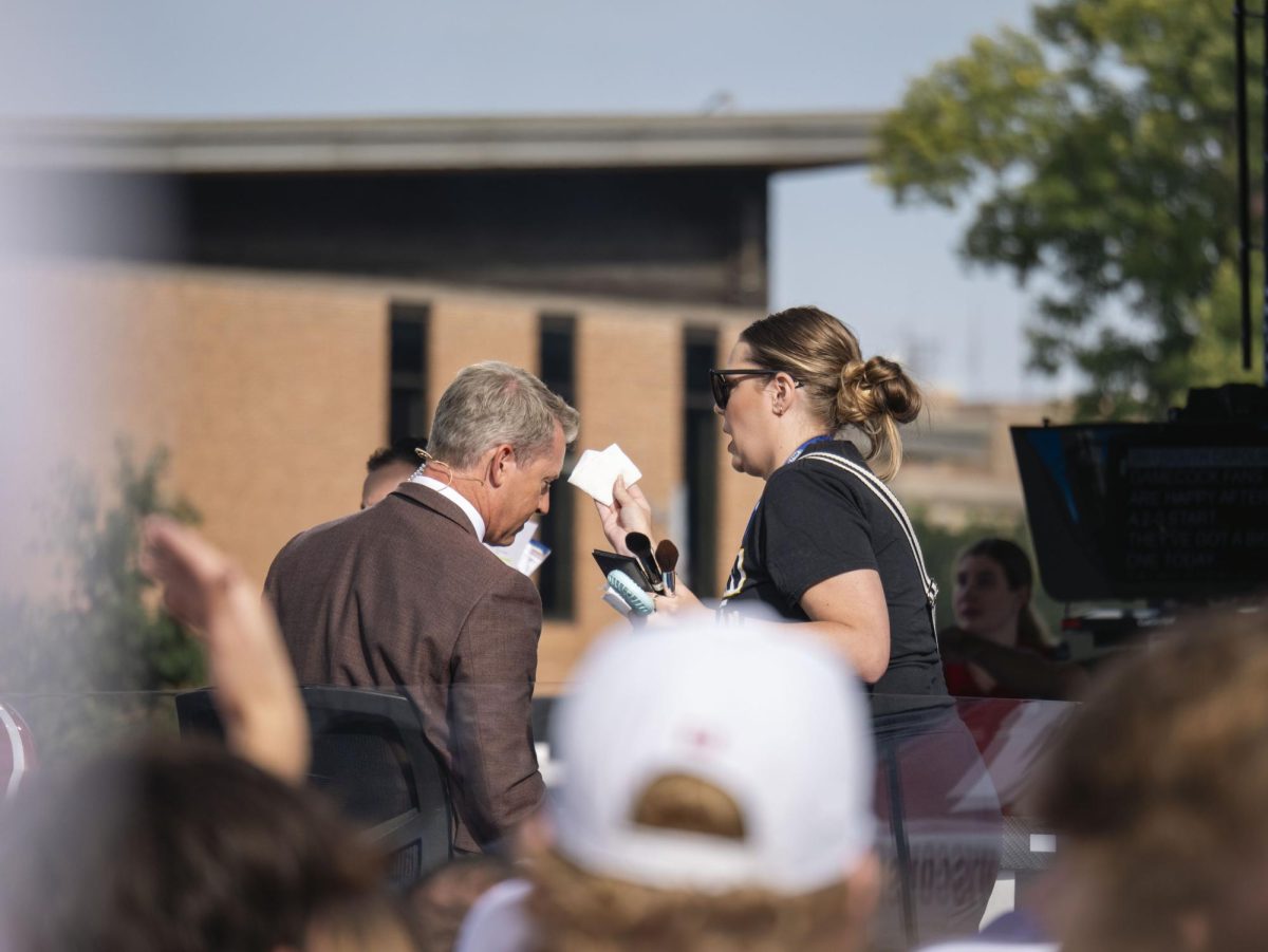 Fox Big Noon Kickoff commentator gets his makeup touched up. 