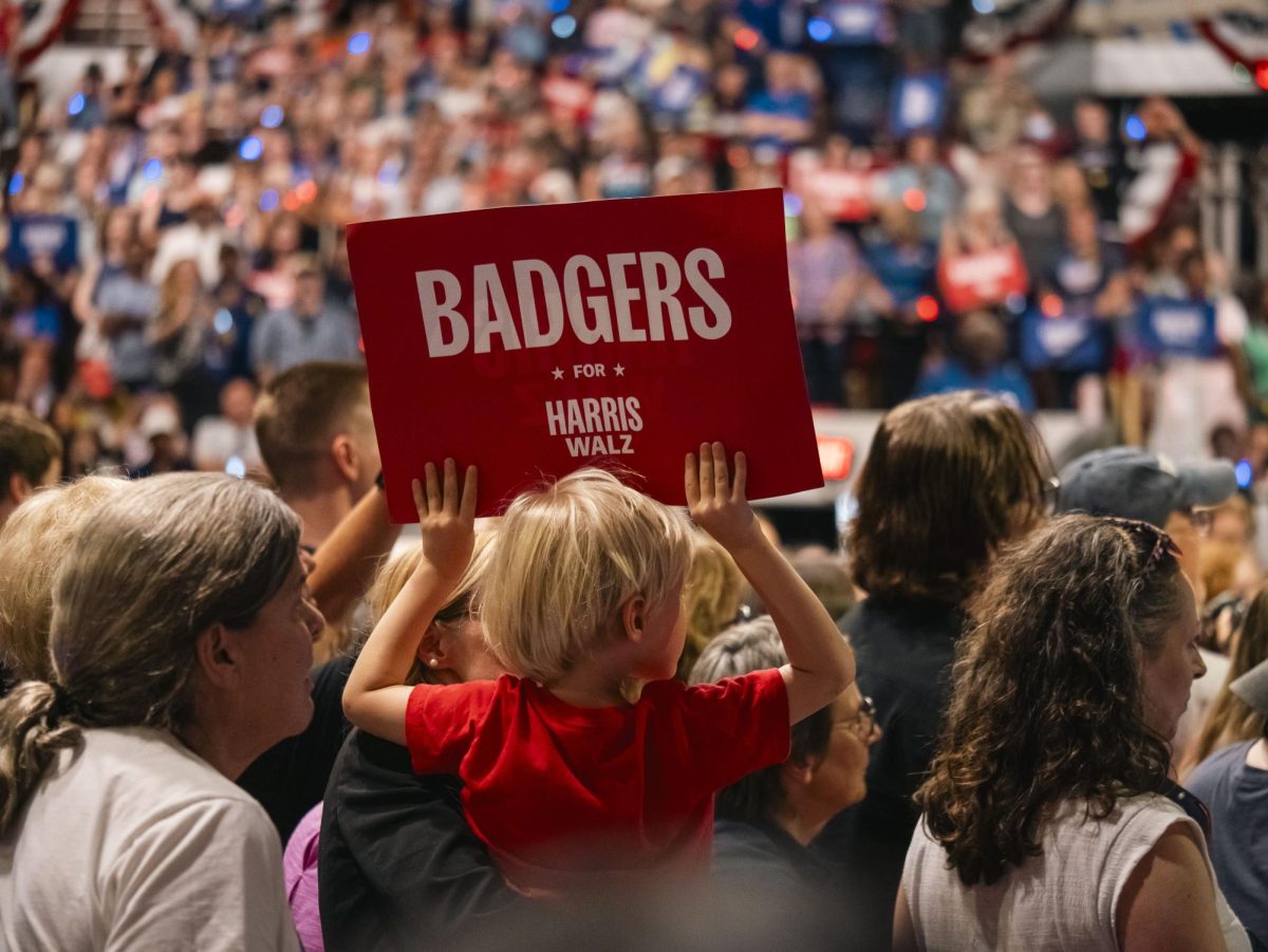 Audience member holding a sign at the Harris rally in Madison. 