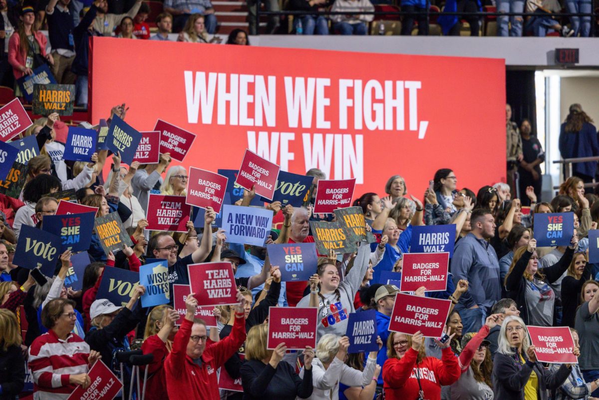 Supporters wave signs at a Harris Walz Campaign event. October 22, 2024