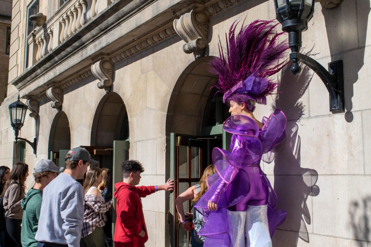 Performer holds open the door at the Memorial Union on the "Party to the Polls" tour. October 23, 2024.