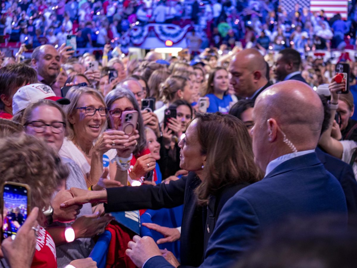 Kamala Harris reaches out to attendees after her speech.  