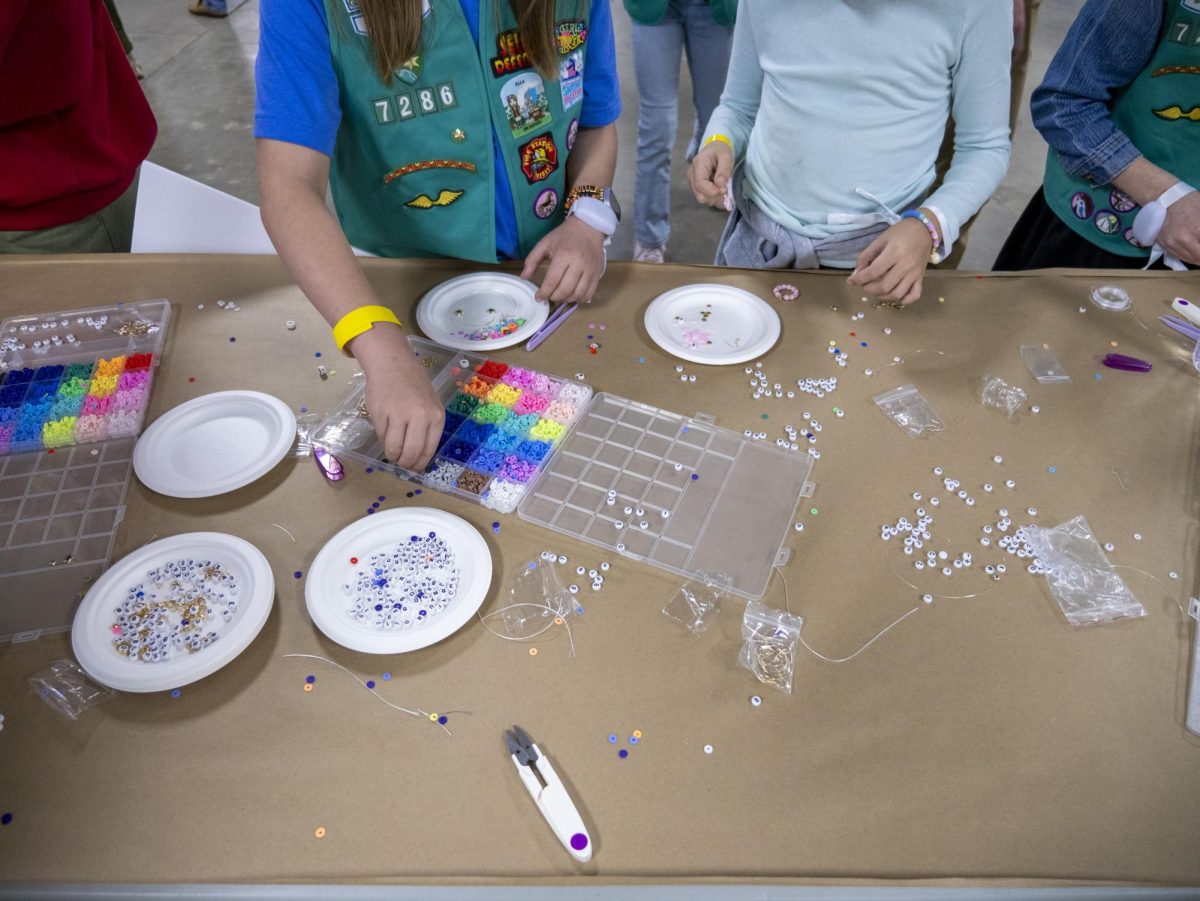 Local girl scouts make friendship bracelets at the Kamala Harris rally. 