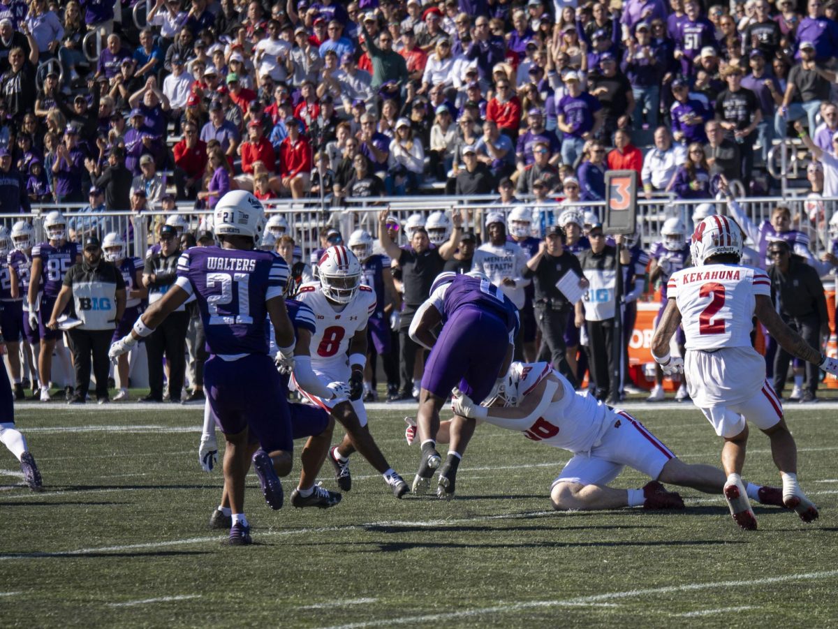 Offensive players tackle Northwestern player after an interception/fumble. 