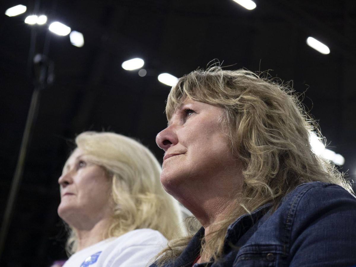 Attendee looks on while Obama speaks at the Harris campaign event. 