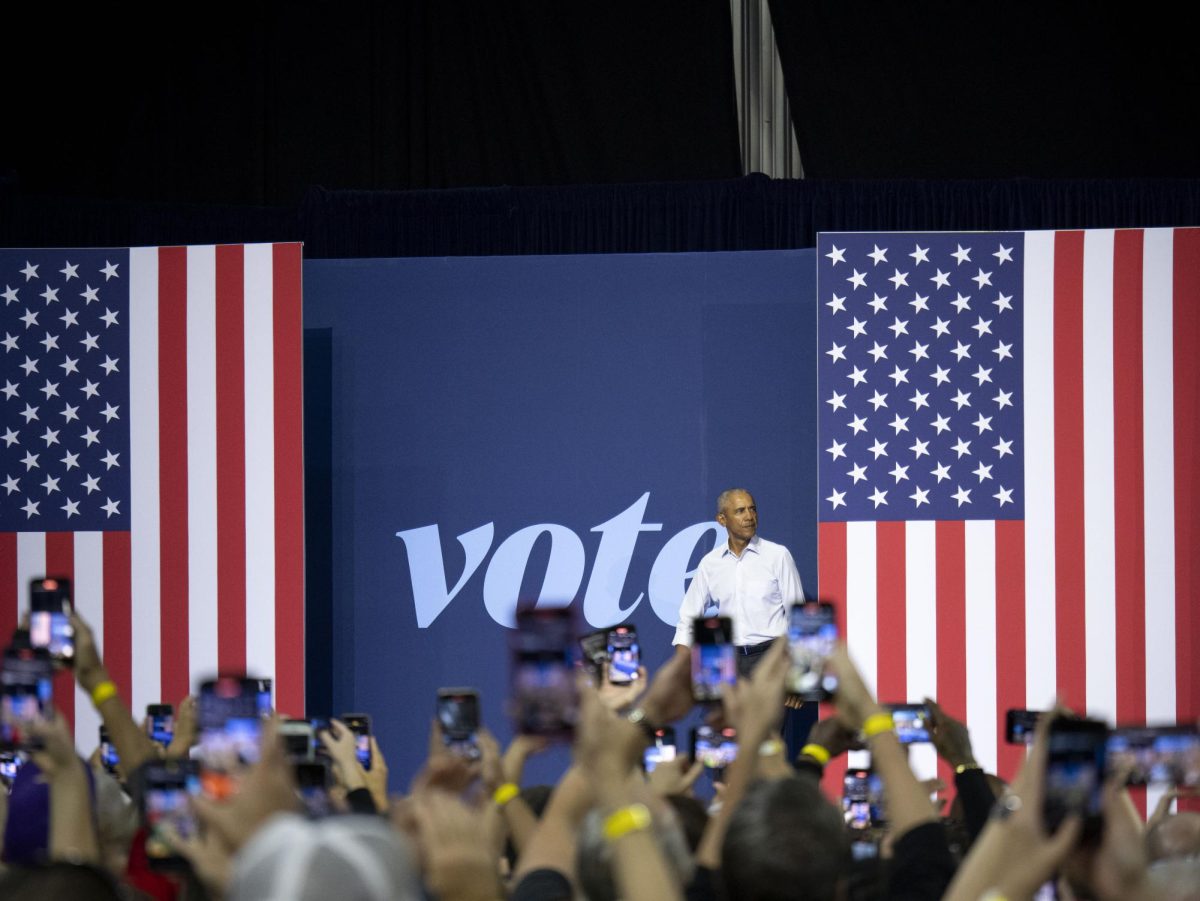 Obama enters the stage at the Harris campaign event. 