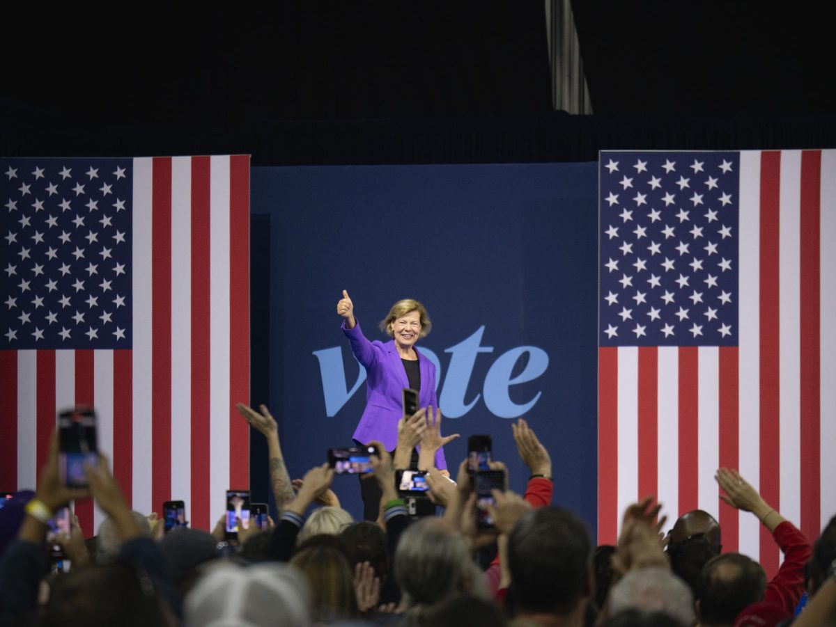 Tammy Baldwin enters the stage at the Harris campaign event. 