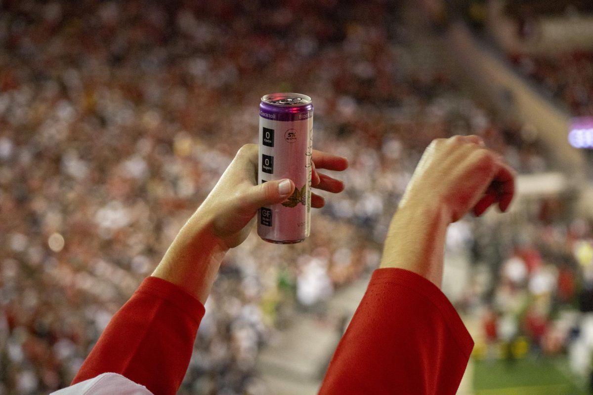 Student holds a can of alcohol purchased at Camp Randall stadium. October 26, 2024. 