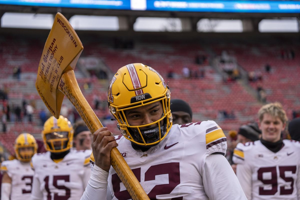 Minnesota player holds Paul Bunyan's axe after defeating the Badgers. November 29, 2024.