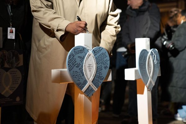 Attendee signs the memorial for victims of the Abundant Life Christian School shooting. December 17, 2024.