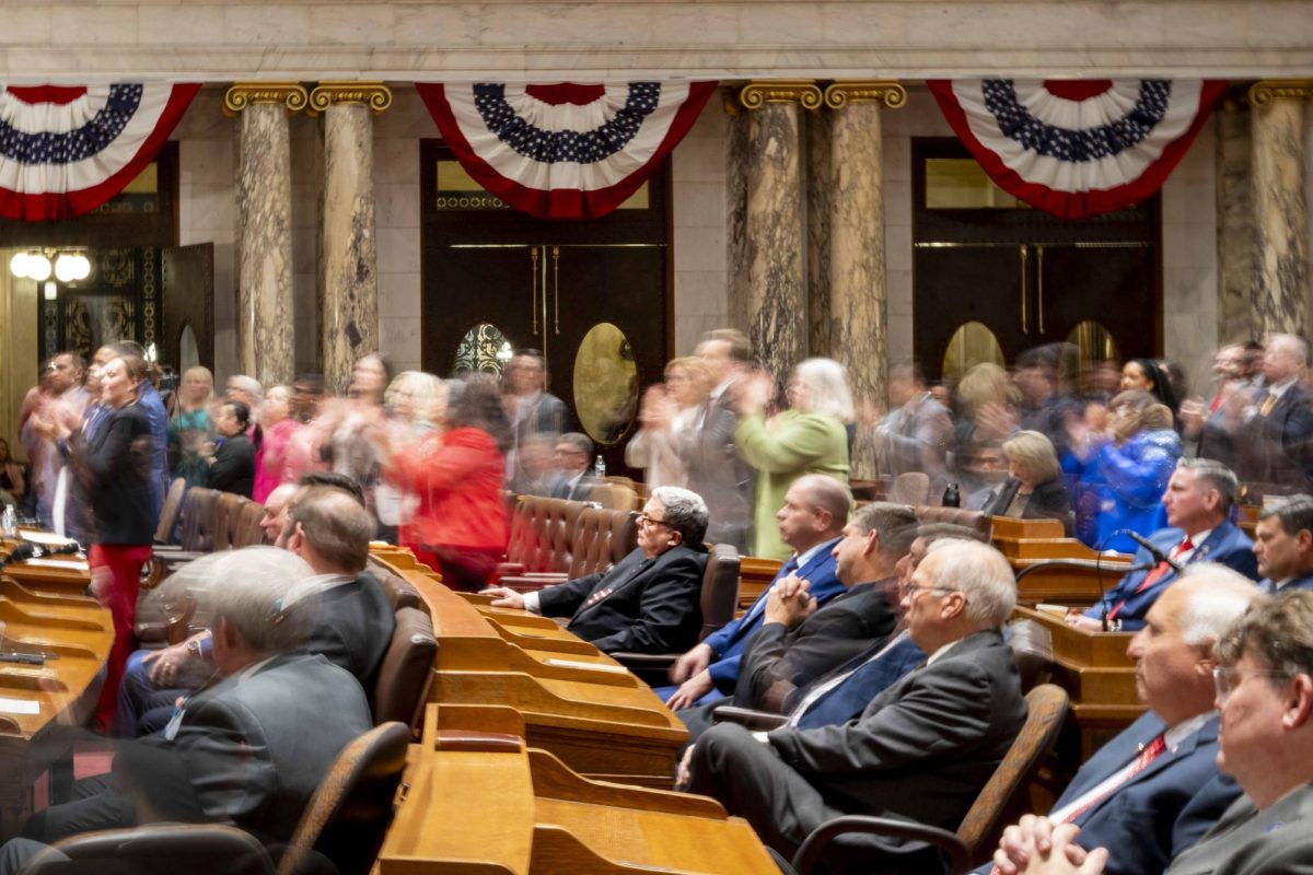 Republican assembly members remain seated while democrat assembly members applaud. January 22, 2025.