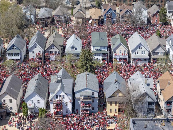 Crowds surround homes near Mifflin Street. April 26, 2025.